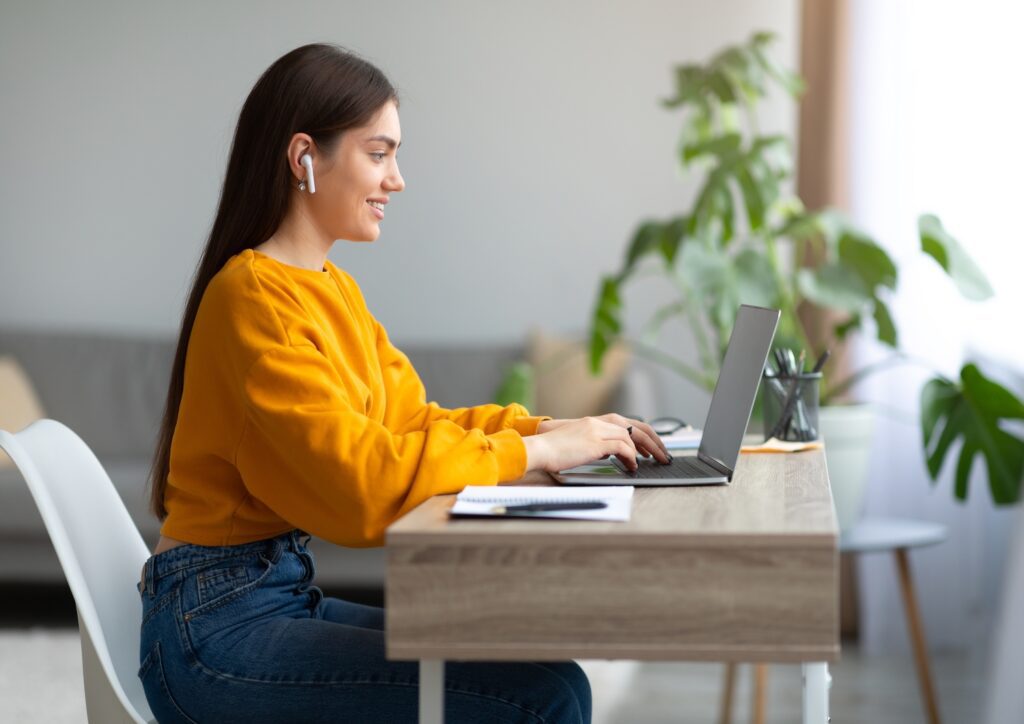 A woman planning her virtual meeting on a laptop.