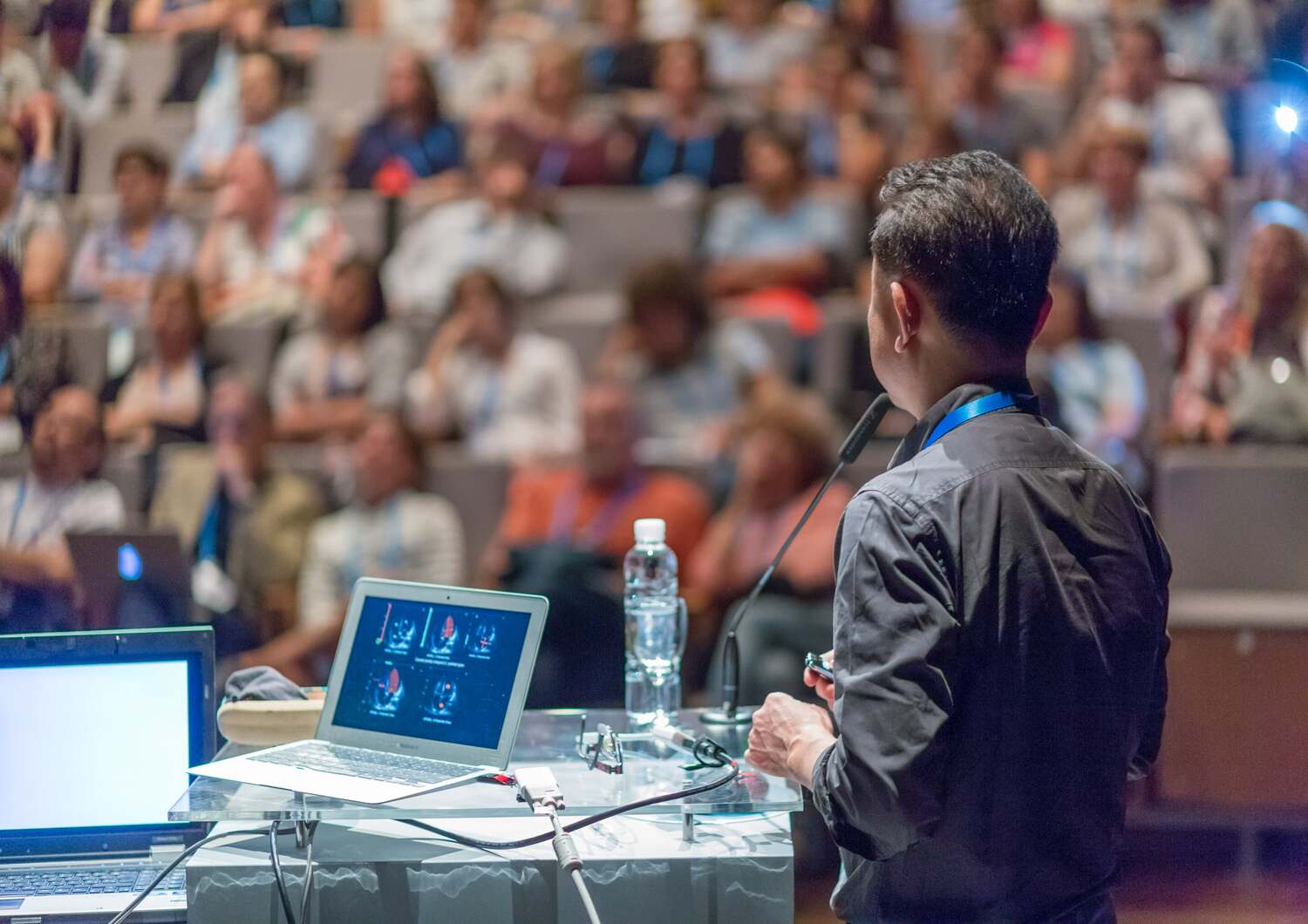 A speaker giving a talk during a scientific talk supported by CTI Meeting Technology.