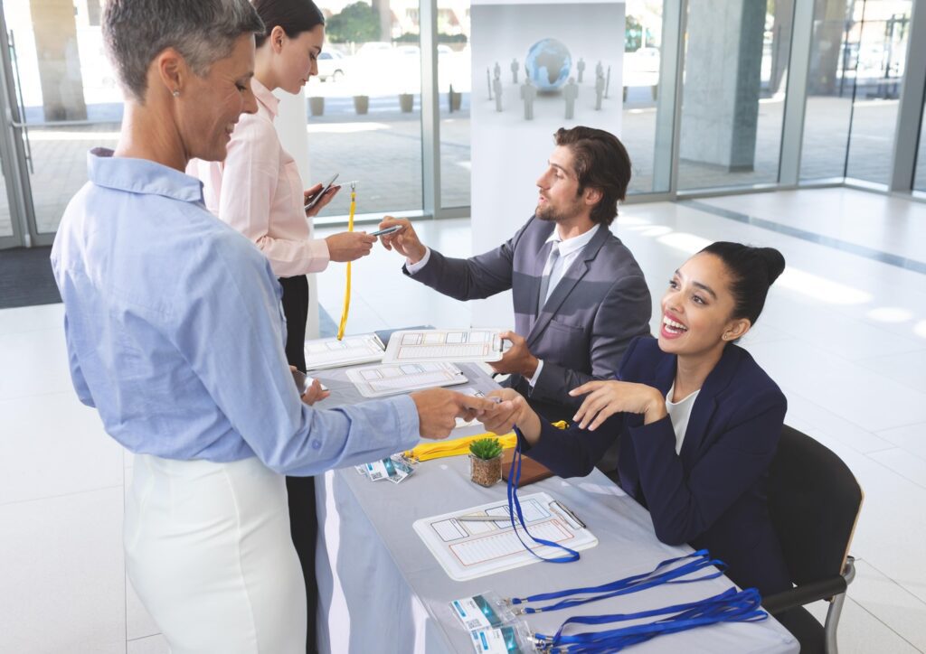 Check-in staff helping attendees during a conference supported by CTI Meeting Technology.