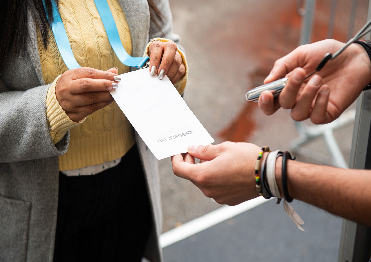 Staff member scanning an attendee's badge to enter the event venue.